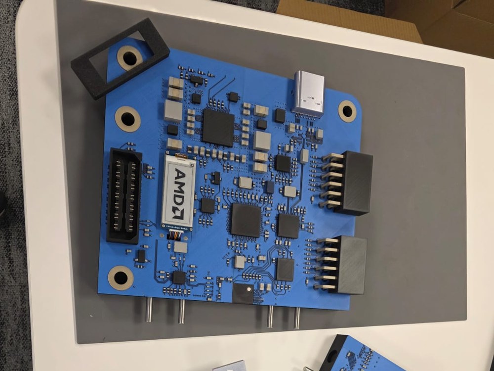 Printed Explorer Board display section with the AMD chip and alignment pins on a table