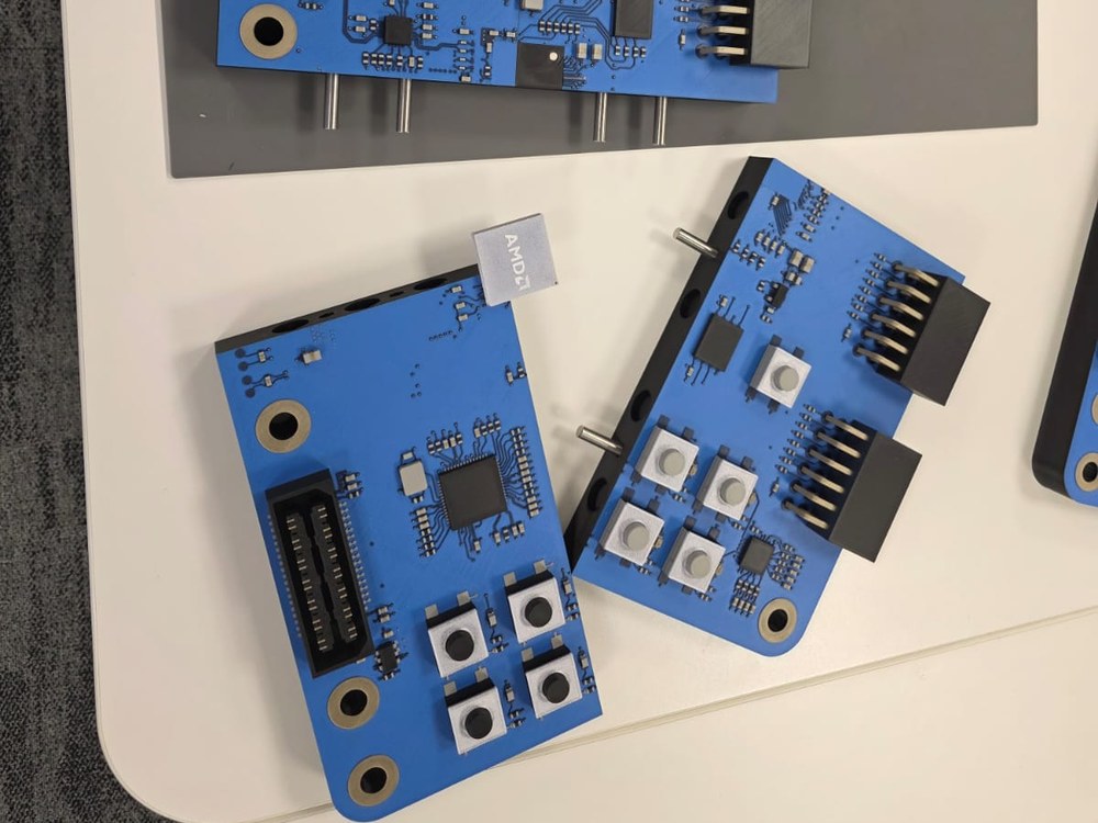 Two printed Explorer Board display sections with buttons, connectors and joining pins