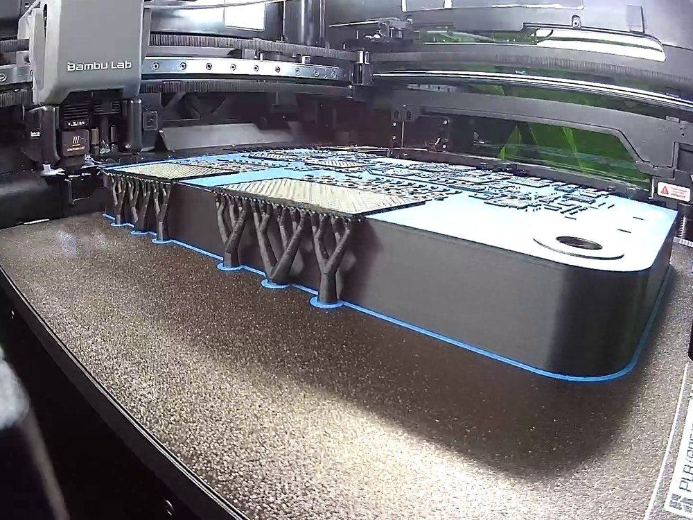 Blue board surface of an Explorer Board display section being 3D printed